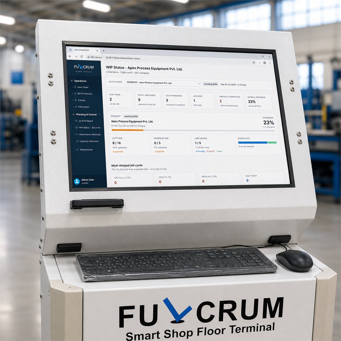 Close-up of the FULCRUM Smart Shop Floor Terminal showing a live FULCRUM-SCP WIP Status board on screen, with keyboard and mouse on the tray